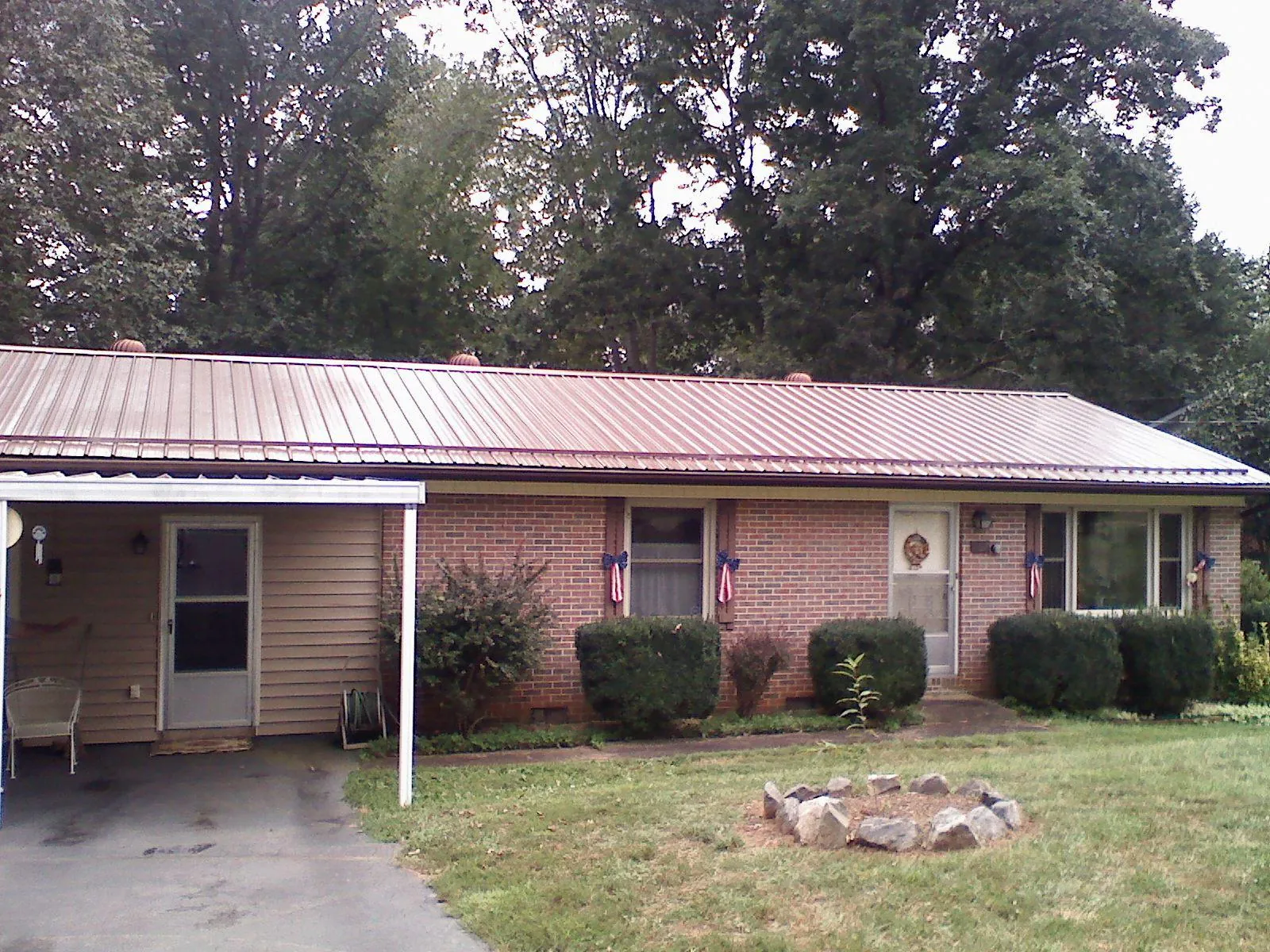 Bronze metal roof and carport on a brick ranch home — Roof Repair work by our crew in Rosalie