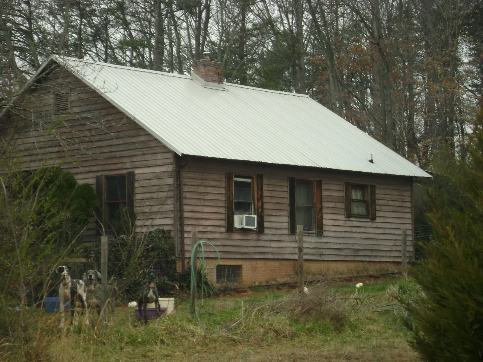 White metal roof on an old wood sided farmhouse, from a Metal Roof Installation job in Rosalie